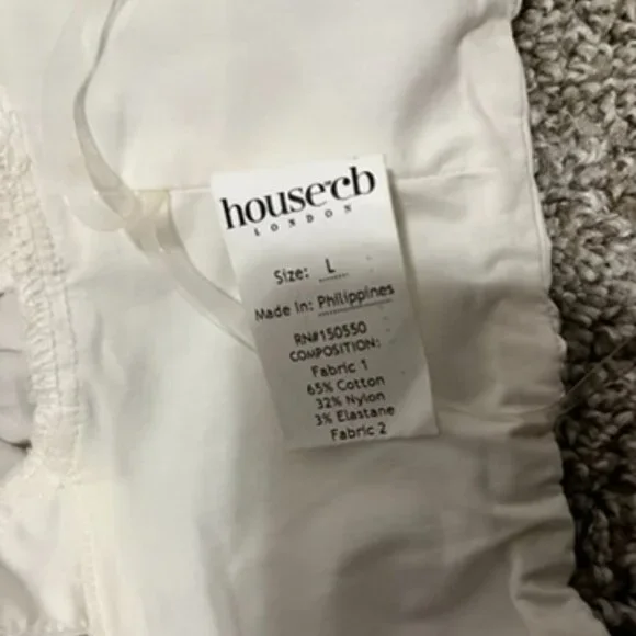 A white crop top with a low neck line, a central bonding detail for structure. - Picture 3 of 3